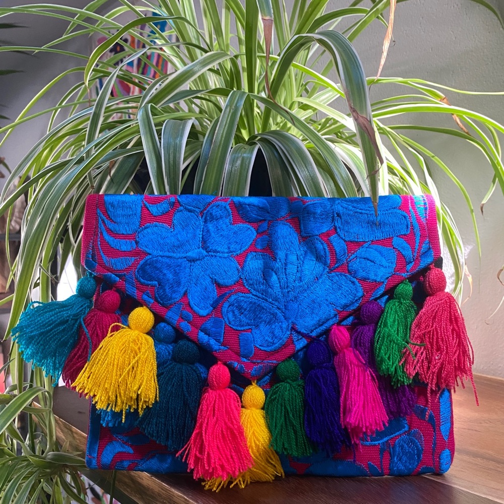 Tassled envelope clutch with zippered closure